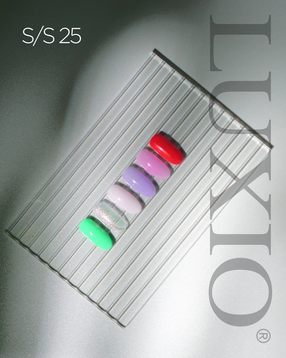 Luxio Soak-Off Gel Polish in Freesia tint, 15ml bottle with colorful gel polish swatches on a white background.