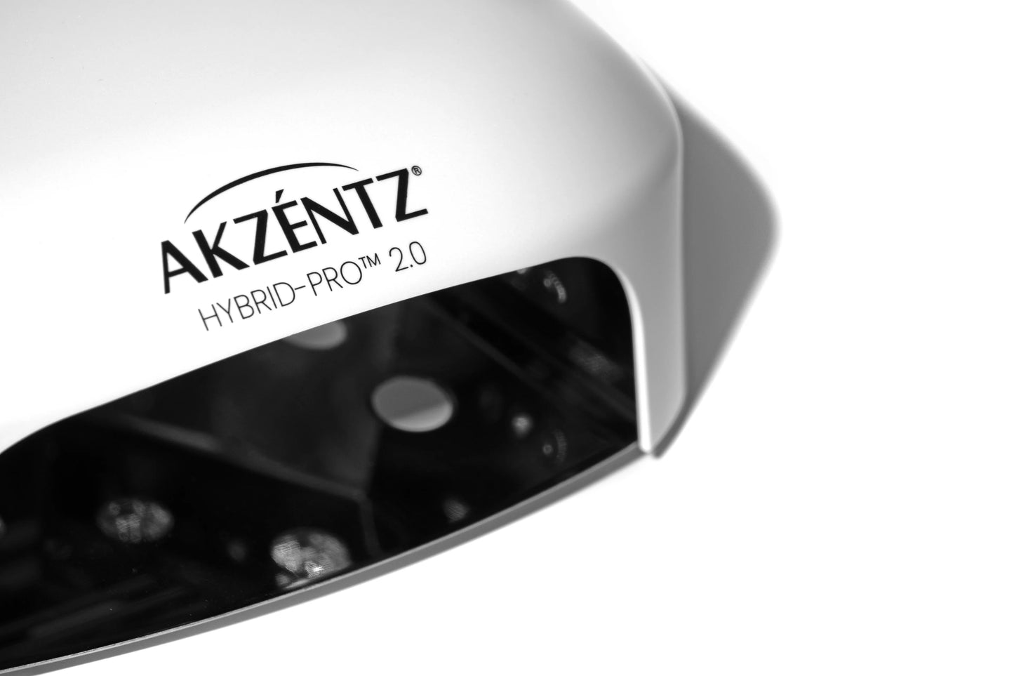 Luxio Akzentz Hybrid Pro 2.0 Smart Light with Luxio gel polish branding and sleek design for professional nail curing.