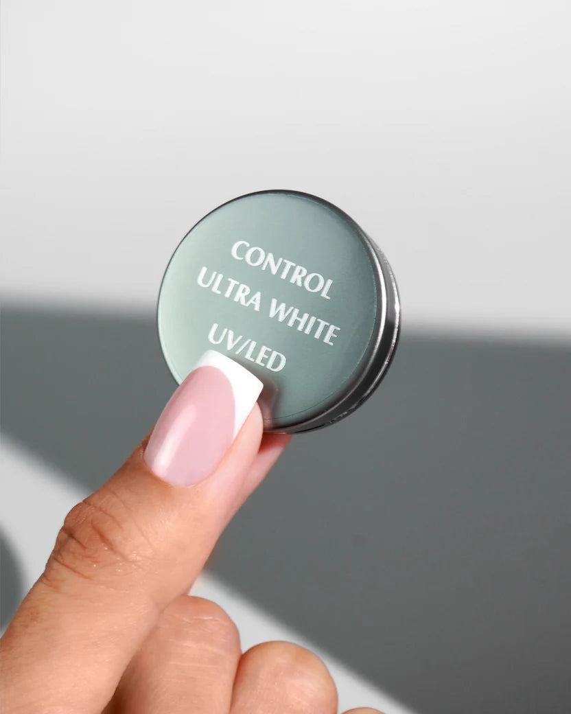 Luxio Akzéntz Pro-Formance Control Ultra White gel for acrylic nails, showing a smooth, white nail tip with a glossy finish.