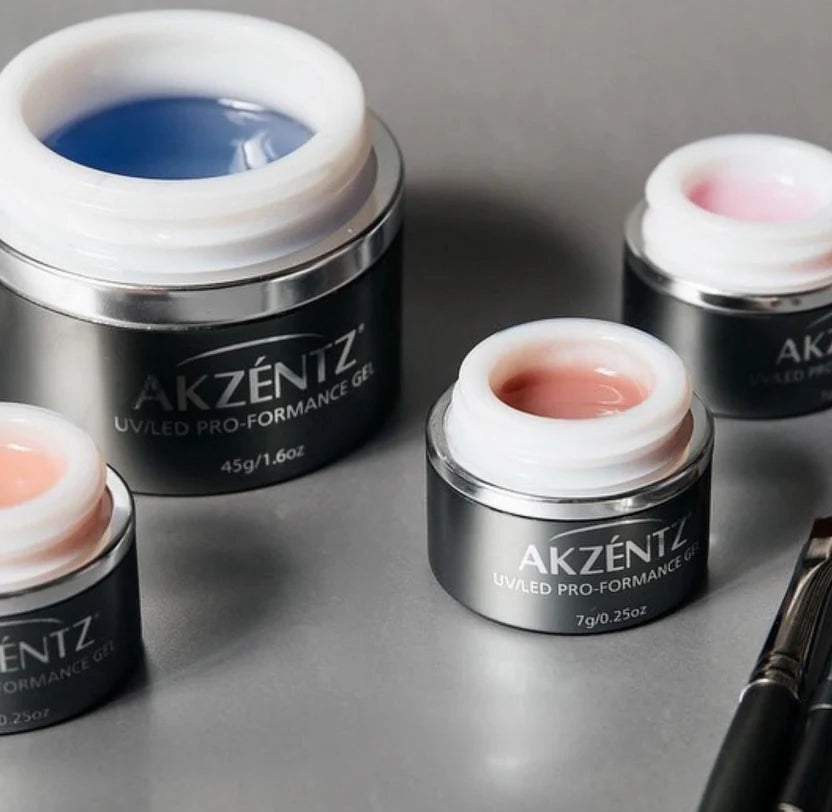 Luxio Akzéntz Pro-Formance Structure .25 oz acrylic nails and tips in a sleek container, ideal for professional nail enhancements.