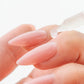 Aprés Nail Cuticle Oil Gel System with Coconut, Sage, and Jasmine for nourishing cuticles, shown in a sleek gel bottle.