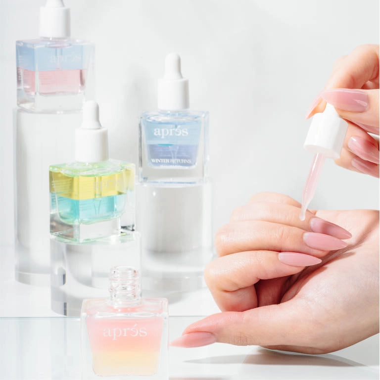 Aprés Nail Cuticle Oil gel system with coconut, sage, and jasmine for nourishing cuticles, shown in a sleek gel bottle.