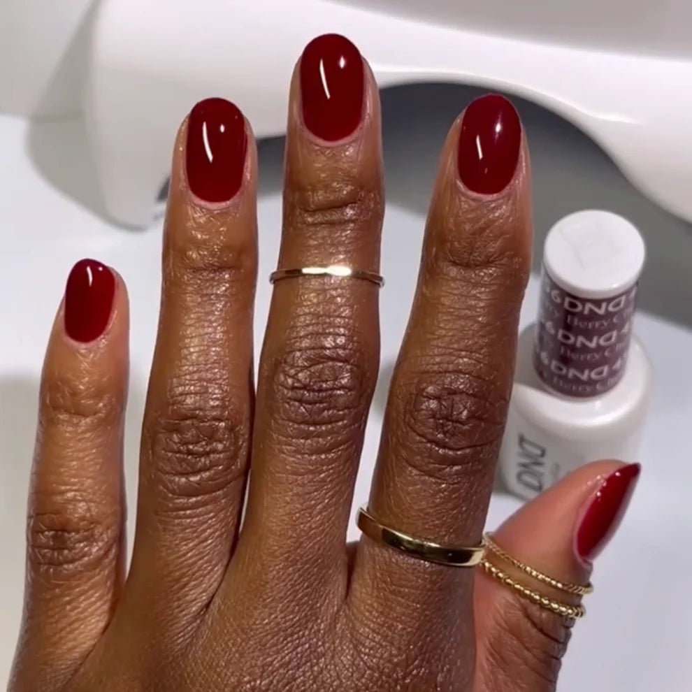 Swatch of DND Daisy Gel Duo Cherry Berry #456 gel nail polish and lacquer showing vibrant pink and red shades on a nail tip.
