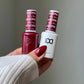 Swatch of DND Daisy Gel Duo Cherry Berry #456 gel nail polish and lacquer showing vibrant cherry berry color on a nail tip.