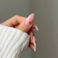 DND Daisy Gel Duo in Chili Pepper, featuring vibrant gel nail polish and lacquer with a heart design on the bottle.