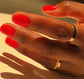 DND Daisy Gel Duo featuring DND Red #563 gel nail polish and lacquer, with a close-up of the vibrant red nail color and glossy finish.