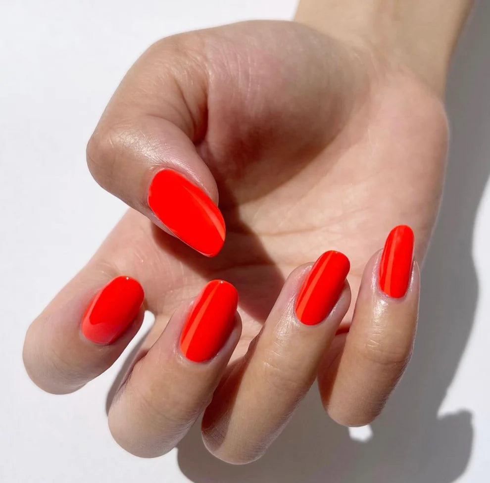 DND Daisy Gel Duo Island Punch #715 with vibrant coral gel nail polish and lacquer for a bold, colorful manicure.
