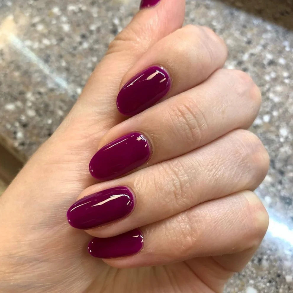 Swatch of DND Daisy Gel Duo Plum #731, gel nail polish and lacquer with a rich purple hue and glossy finish.