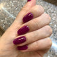 Swatch of DND Daisy Gel Duo Plum #731, gel nail polish and lacquer with a rich purple hue and glossy finish.