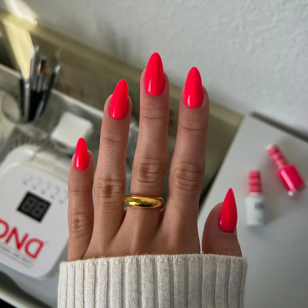 Swatch of DND Daisy Gel Duo Strawberry Kiss #561 gel nail polish and lacquer on nail, showcasing the vibrant strawberry pink color