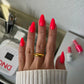 Swatch of DND Daisy Gel Duo Strawberry Kiss #561 gel nail polish and lacquer on nail, showcasing the vibrant strawberry pink color