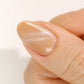 DND DC Gel Polish in Caramel Lullaby, a nude cream shade with velvet cat-eye shimmer, shown as a swatch on nails.