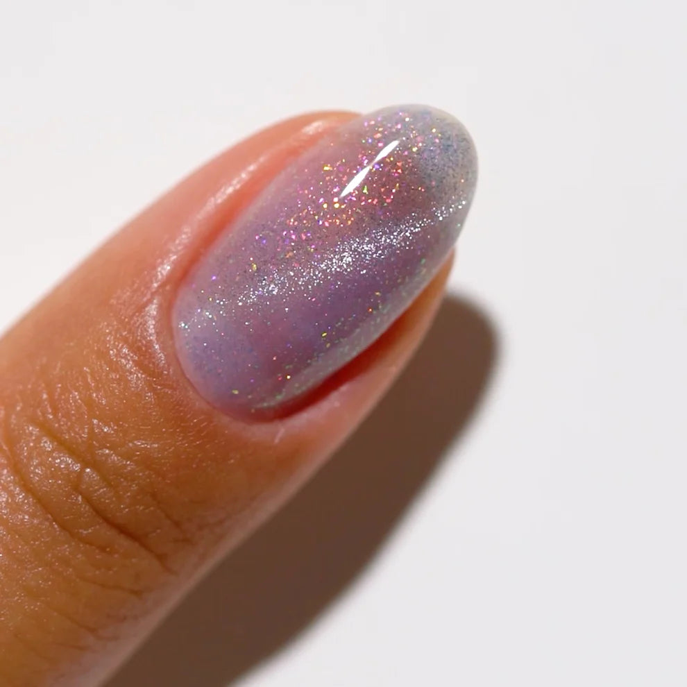 DND DC Gel Polish in Celestial Prism #22, showcasing a vibrant cat eye effect with shimmering cosmic colors and a glossy finish.