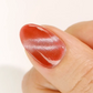 DND DC Gel Polish Cleocatra #26 cat eye gel with velvet cream and shimmer, displayed on a swatch nail showing red russet tones
