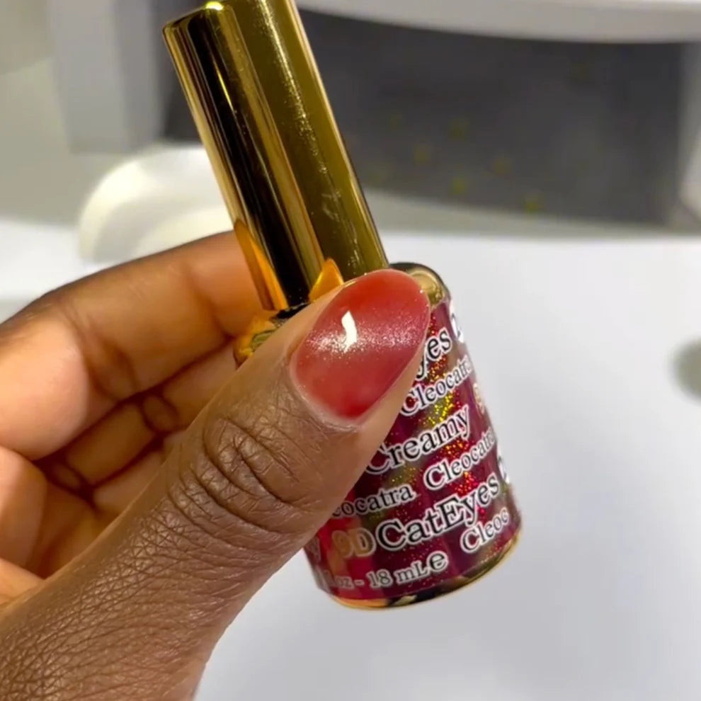 DND DC Gel Cat Eye polish in Cleocatra shade, showing a swatch of deep, shimmering gel nail color with a cat eye effect.