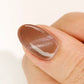DND DC Gel Polish in Cocoa Whiskers shade, showing a brown velvet cream with cat eye shimmer effect on nails.