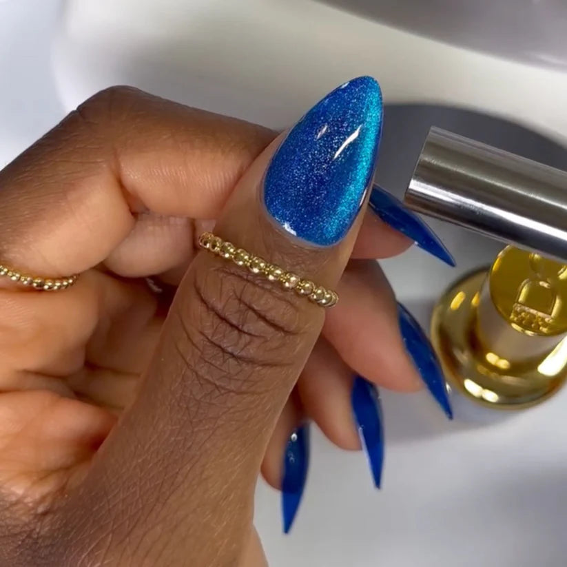 DND DC Gel Polish in Galactic Sapphire #04, a vibrant blue gel cat eye polish with shimmering effects, shown as a swatch.