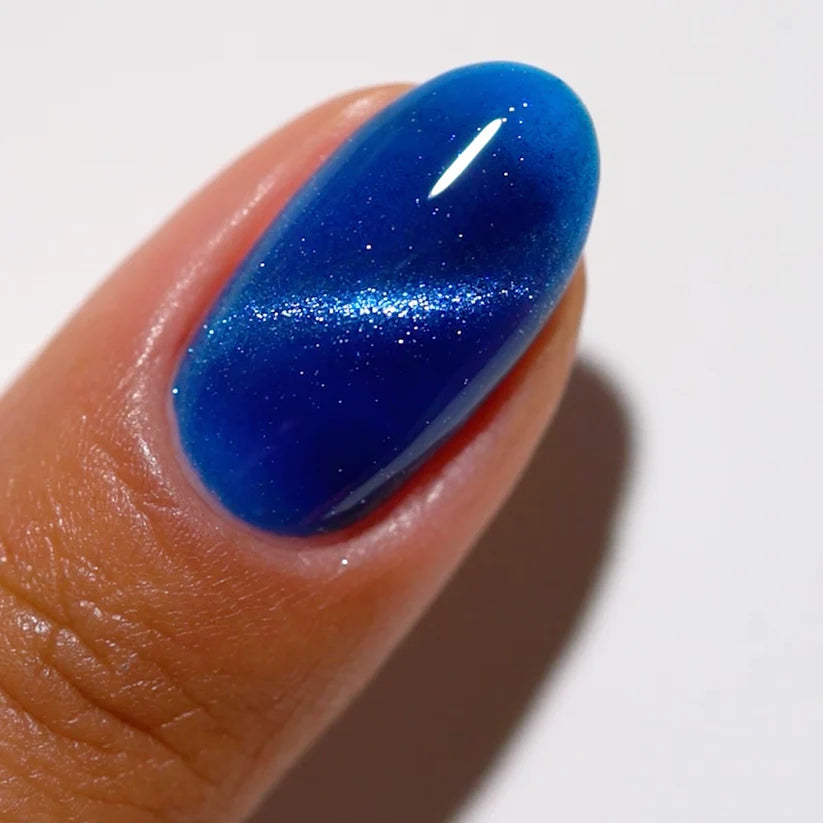 DND DC Gel Polish Cat Eye in Galactic Sapphire #04 showing a vibrant blue gel with a shimmering galaxy effect on a nail.