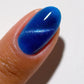 DND DC Gel Polish Cat Eye in Galactic Sapphire #04 showing a vibrant blue gel with a shimmering galaxy effect on a nail.
