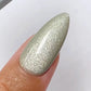 DND DC Gel Polish Misty Moss #29 with velvet cat eye shimmer for elegant, moss-green nail designs.