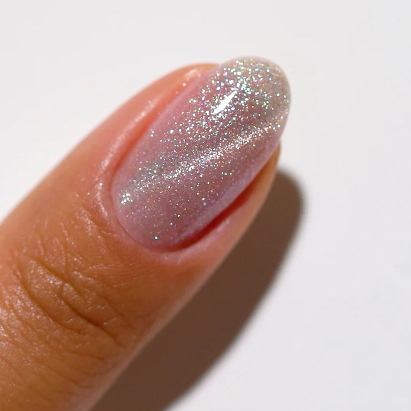 DND DC Gel Polish in Opal Elixir #14 featuring a glossy, multi-dimensional cat eye effect with shimmer and depth.