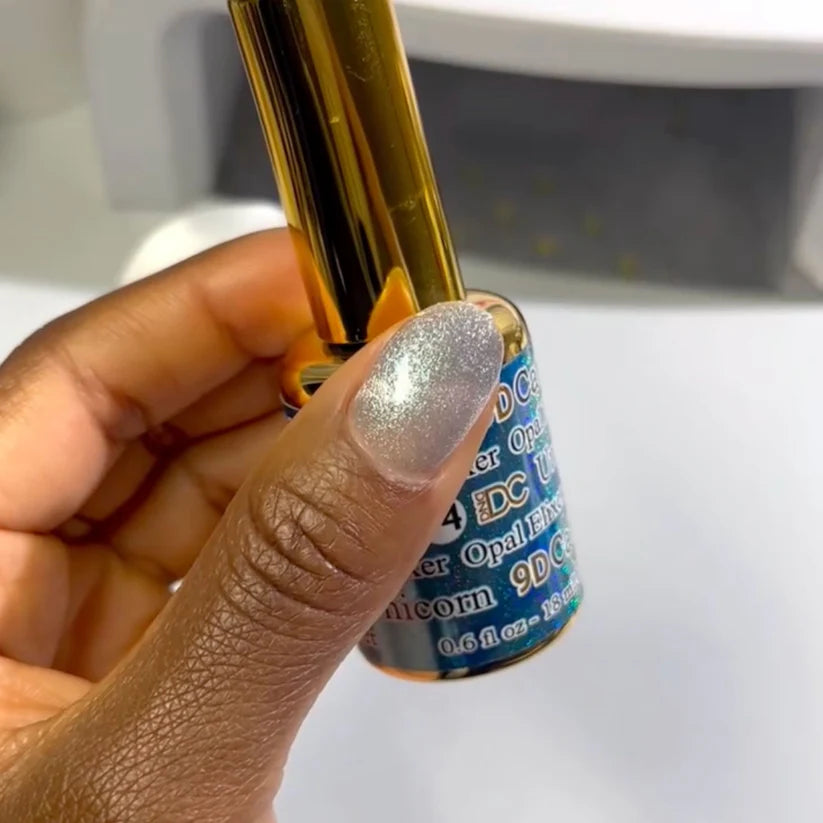 DND DC Gel Polish in Opal Elixir #14, a vibrant cat eye gel with shimmering opal finish, shown on a nail swatch.