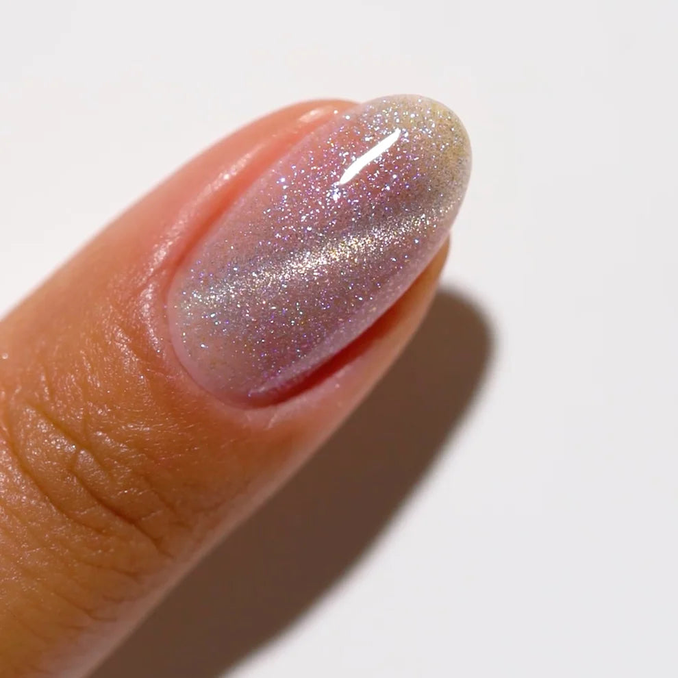 DND DC Gel Polish in Pixie Wings #23 featuring a vibrant cat eye gel nail design with shimmering pink and purple hues.