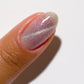 DND DC Gel Polish in Pixie Wings #23 featuring a vibrant cat eye gel nail design with shimmering pink and purple hues.