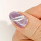 DND DC Gel Polish in Royal Paws #34 with mauve and purple cat eye shimmer effect on nails.