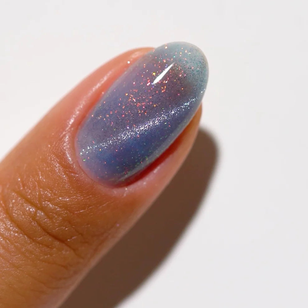 DND DC Gel Polish Cat Eye in Seascape shade showing vibrant blue-green gel with shimmering cat eye effect on nails