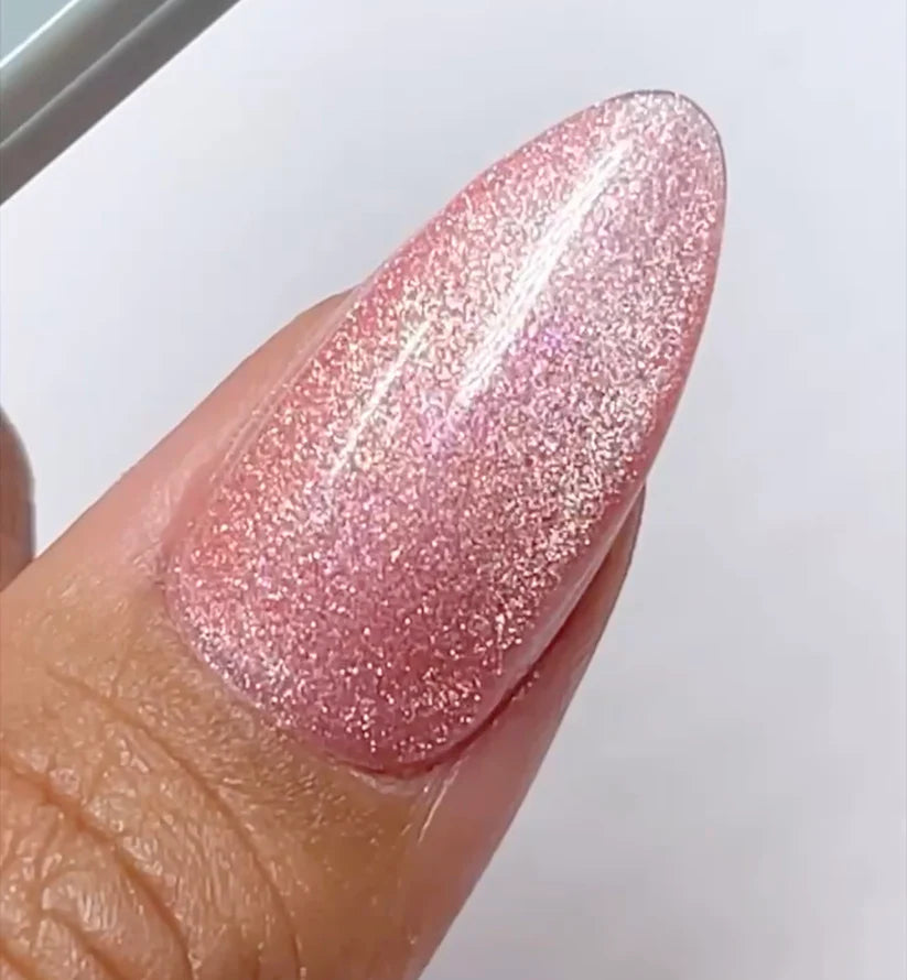 DND DC Gel Polish in Sugar Floss #16, featuring a vibrant pink cat eye nail design with a shiny, reflective finish.
