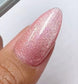 DND DC Gel Polish in Sugar Floss #16, featuring a vibrant pink cat eye nail design with a shiny, reflective finish.