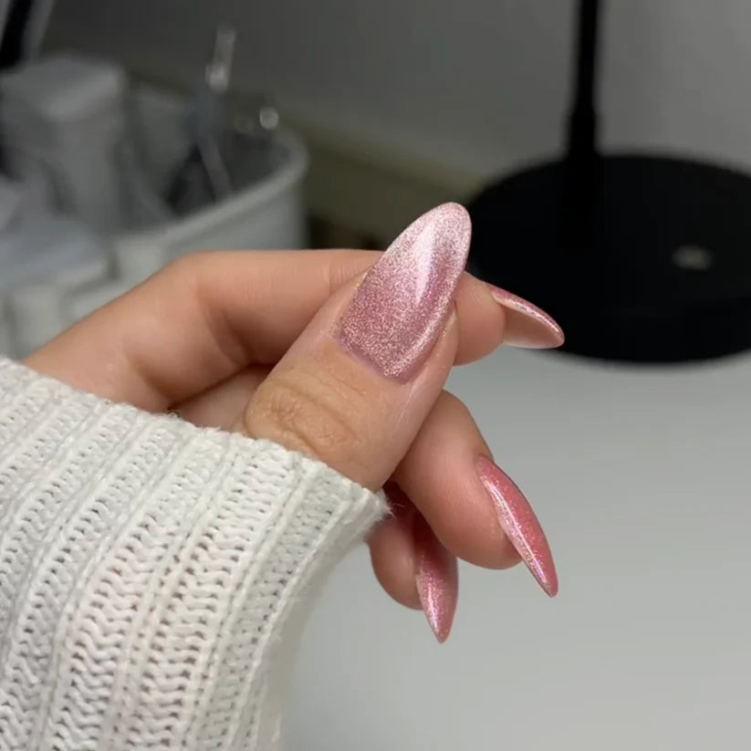 DND DC Gel Polish in Sugar Floss #16 featuring a sparkly, unicorn-inspired cat eye nail design with pink and glitter accents.