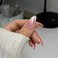 DND DC Gel Polish in Sugar Floss #16 featuring a sparkly, unicorn-inspired cat eye nail design with pink and glitter accents.