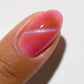 DND DC Gel Polish Cat Eye Twilight Blush #01 showcasing a shimmering pink and purple gel nail design with a cat eye effect