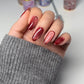 DND DC Gel Polish in Wine N' Lust #06, deep burgundy cat eye nail polish with shimmering finish, shown in a close-up image