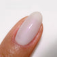 Swatch of DND DC Gel Duo Coconut Silk gel nail polish and lacquer, showcasing the smooth, glossy light beige color.