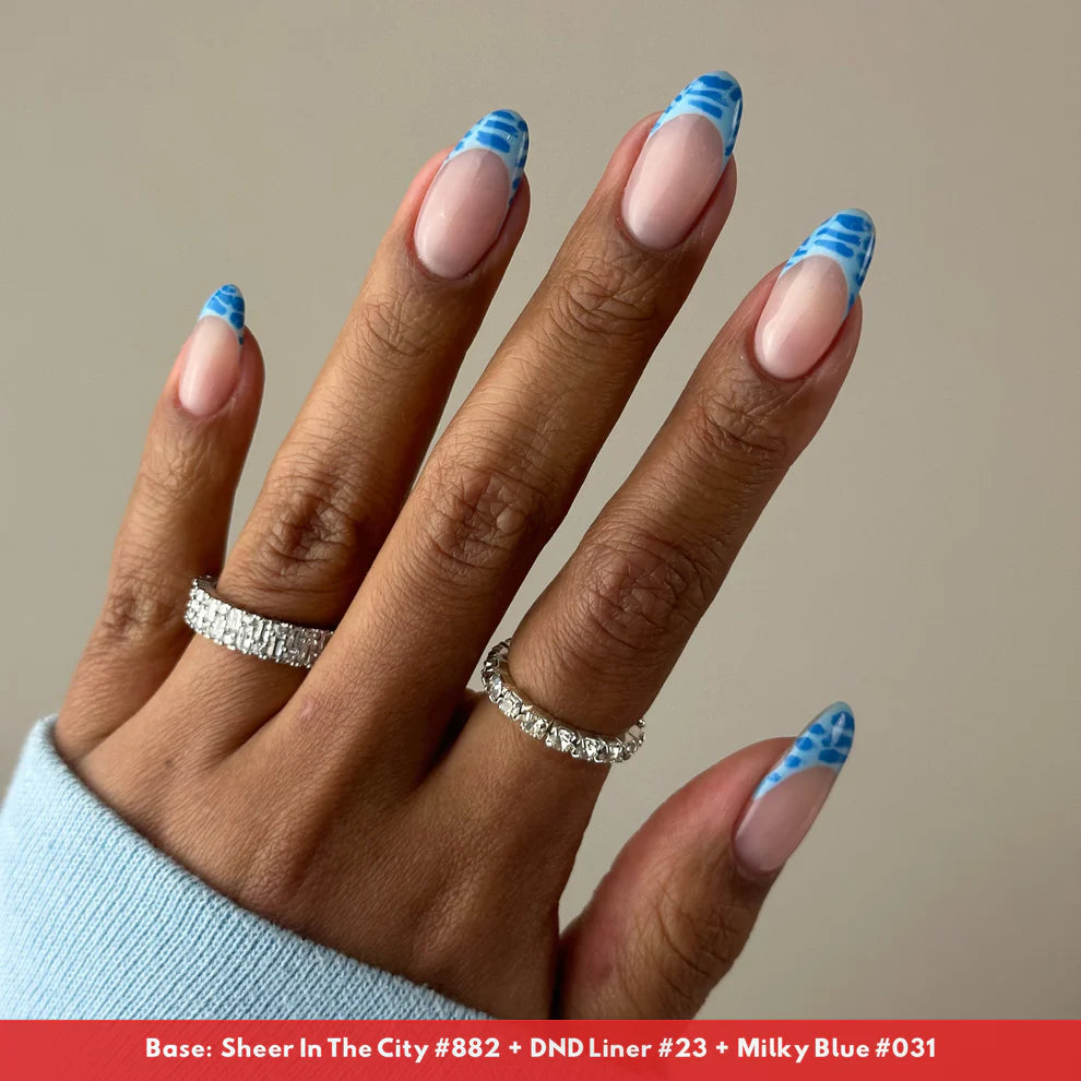 DND DC Gel Duo Milky Blue #031 gel nail polish and lacquer set, smooth finish, displayed with a nail art design on a hand.