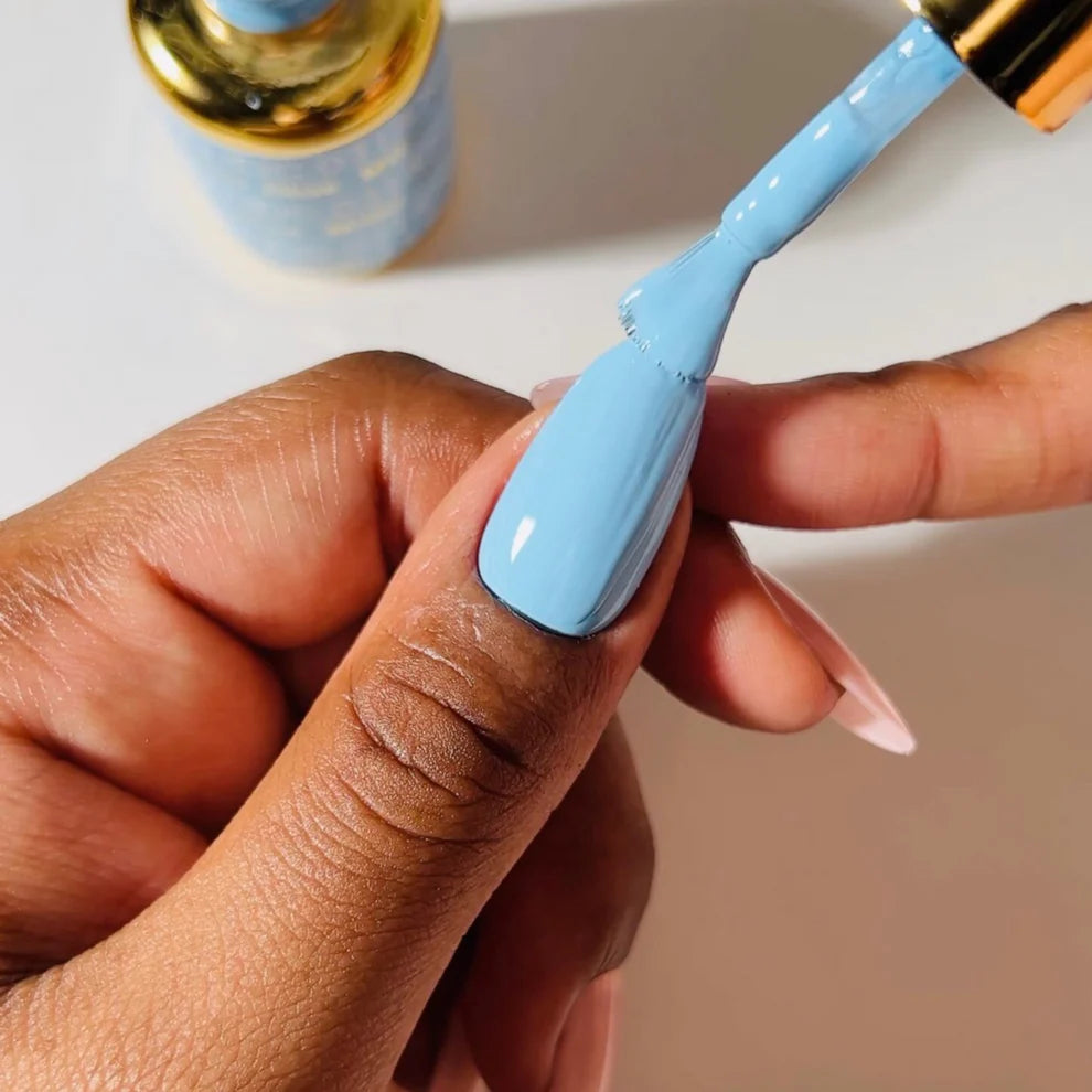 Swatch of DND DC Gel Duo Milky Blue #031 gel nail polish and lacquer on a nail tip, showcasing a smooth, glossy finish.