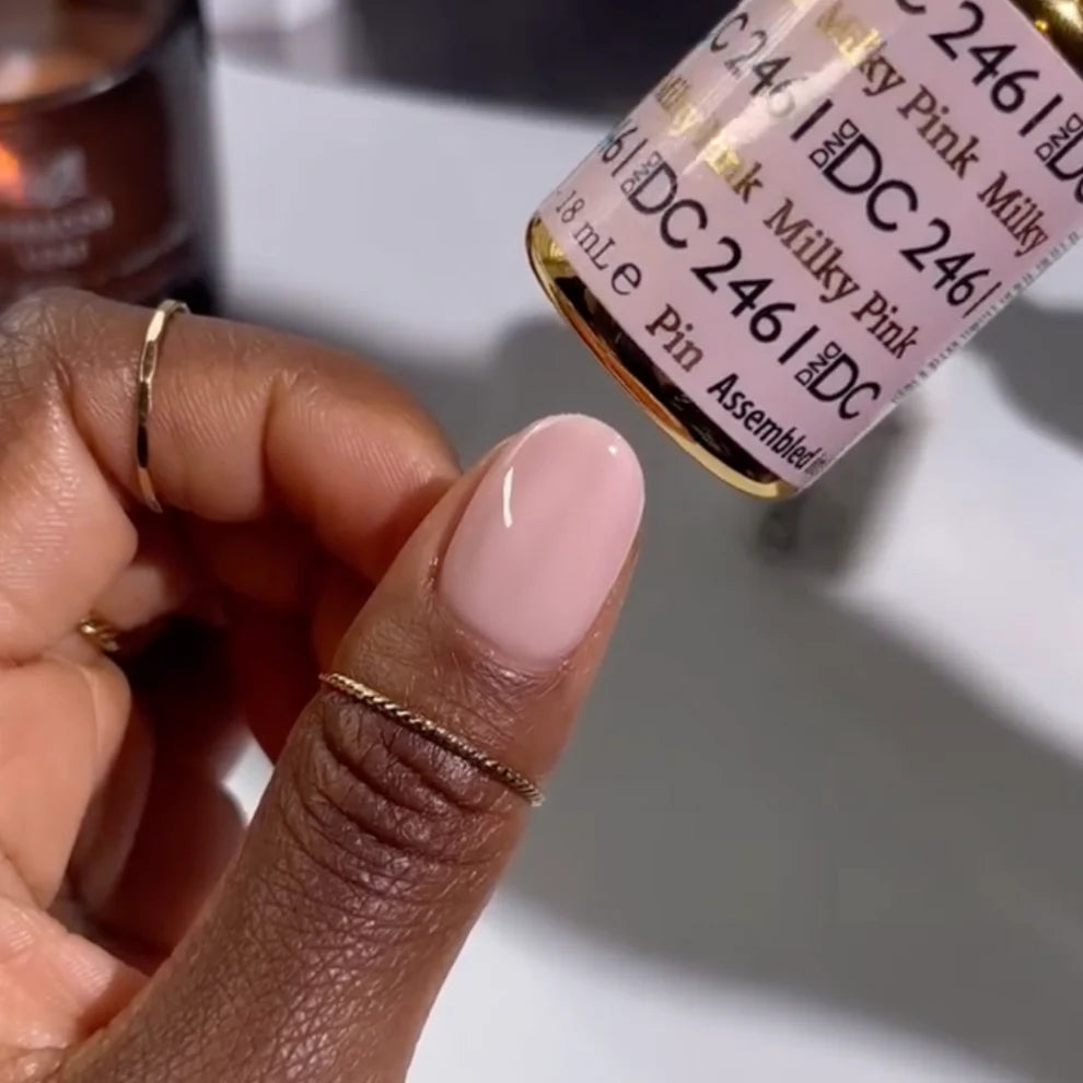 Swatch of DND DC Gel Duo Milky Pink #2461 gel nail polish and lacquer on a nail tip.