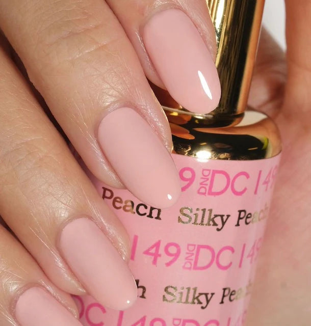 DND DC Gel Duo Silky Peach #149 gel nail polish and lacquer set, showing two bottles of DND DC GEL DUO nail products.