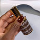 Swatch of DND DC Gel Duo Walnut Brown #052 gel nail polish and lacquer showing glossy finish and rich brown color.