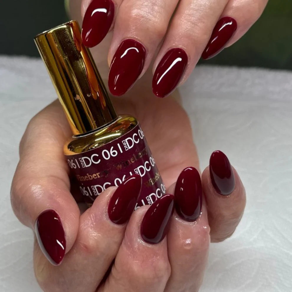 Swatch of DND DC Gel Duo Wine Berry #061 gel nail polish and lacquer in vibrant wine berry shade with a glossy finish.