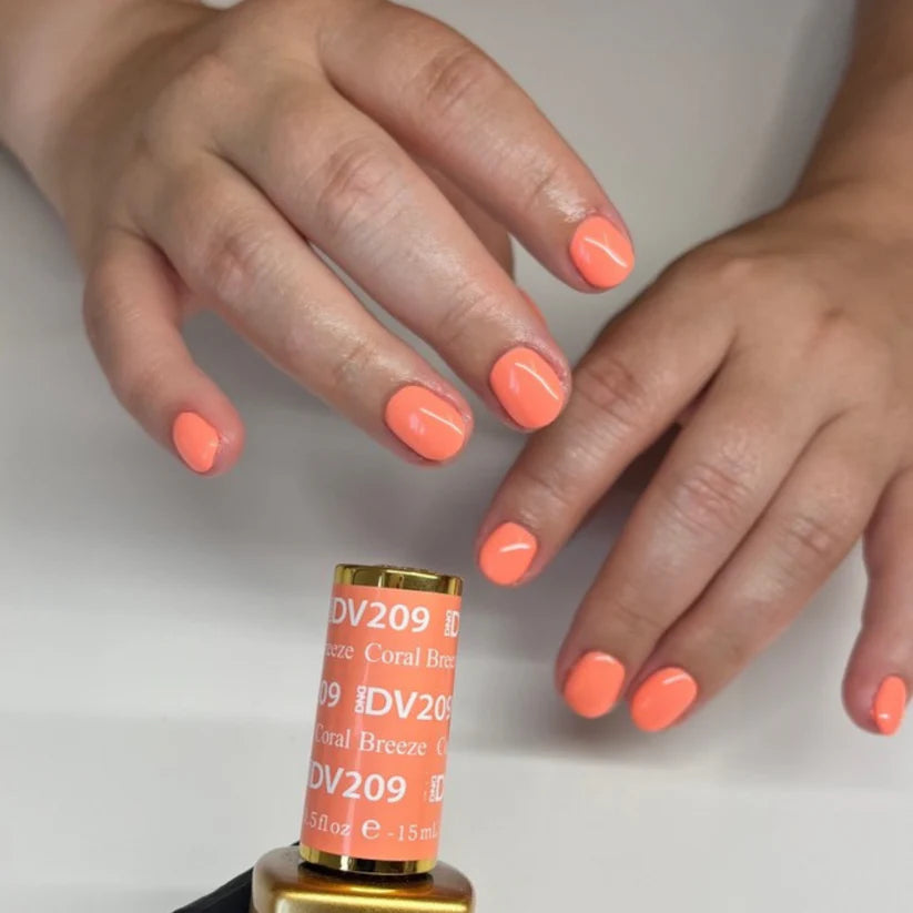 Swatch of DND Diva Duo Gel & Polish in Coral Breeze 209 showcasing vibrant coral nail color and glossy finish.
