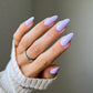 Swatch of DND Diva Duo Gel & Polish in Dainty Lavender 103, showing a smooth, lavender gel nail polish and lacquer finish.