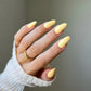 DND Diva Duo Gel & Polish in Dandelion 084 swatch showing bright yellow gel nail polish and lacquer finish.