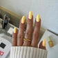 DND Diva Duo Gel & Polish Dandelion 084 swatch showing bright yellow gel nail polish and lacquer finish on nails