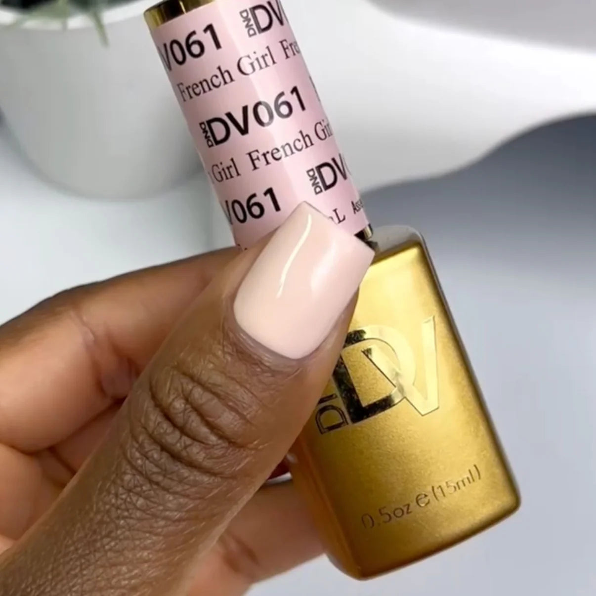 Swatch of DND Diva Duo Gel & Polish in French Girl 061 showing a stylish pink and nude nail design with shiny finish.