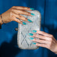 DND Diva Gel high note 318 clear gel nail polish swatch showing vibrant, glossy finish on a nail sample.