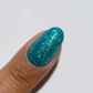 DND Diva Gel High Note 318 clear gel nail polish swatch showing vibrant, shiny blue color on a nail.
